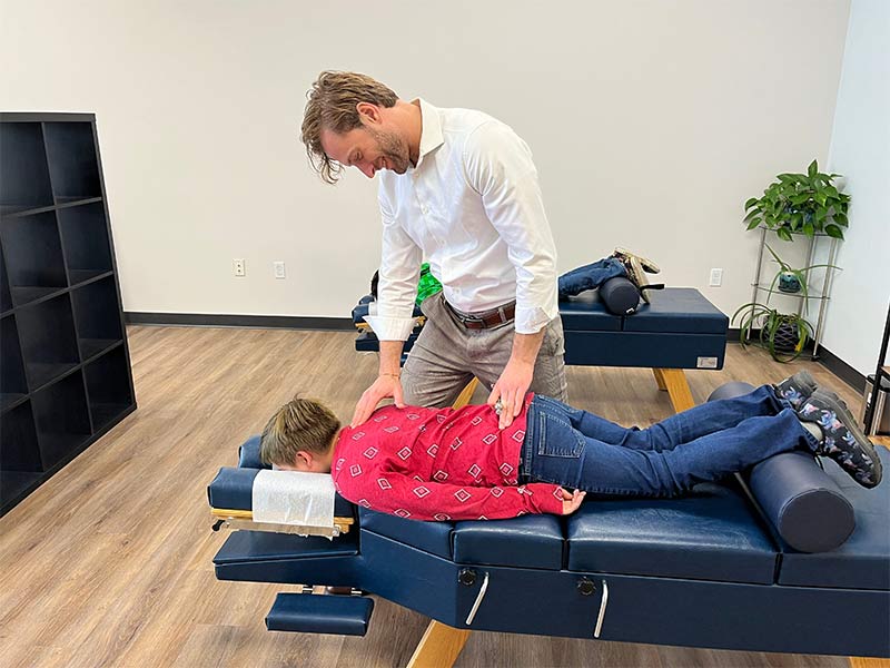 Child patient getting a chiropractic exam by Dr. Hagan
